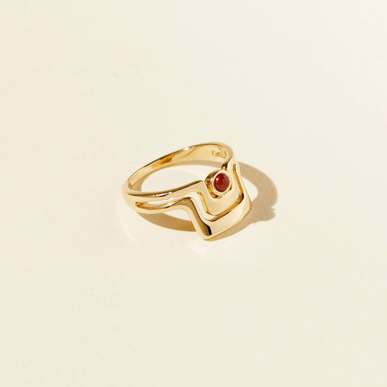 top angled view of the grand ring on a beige background