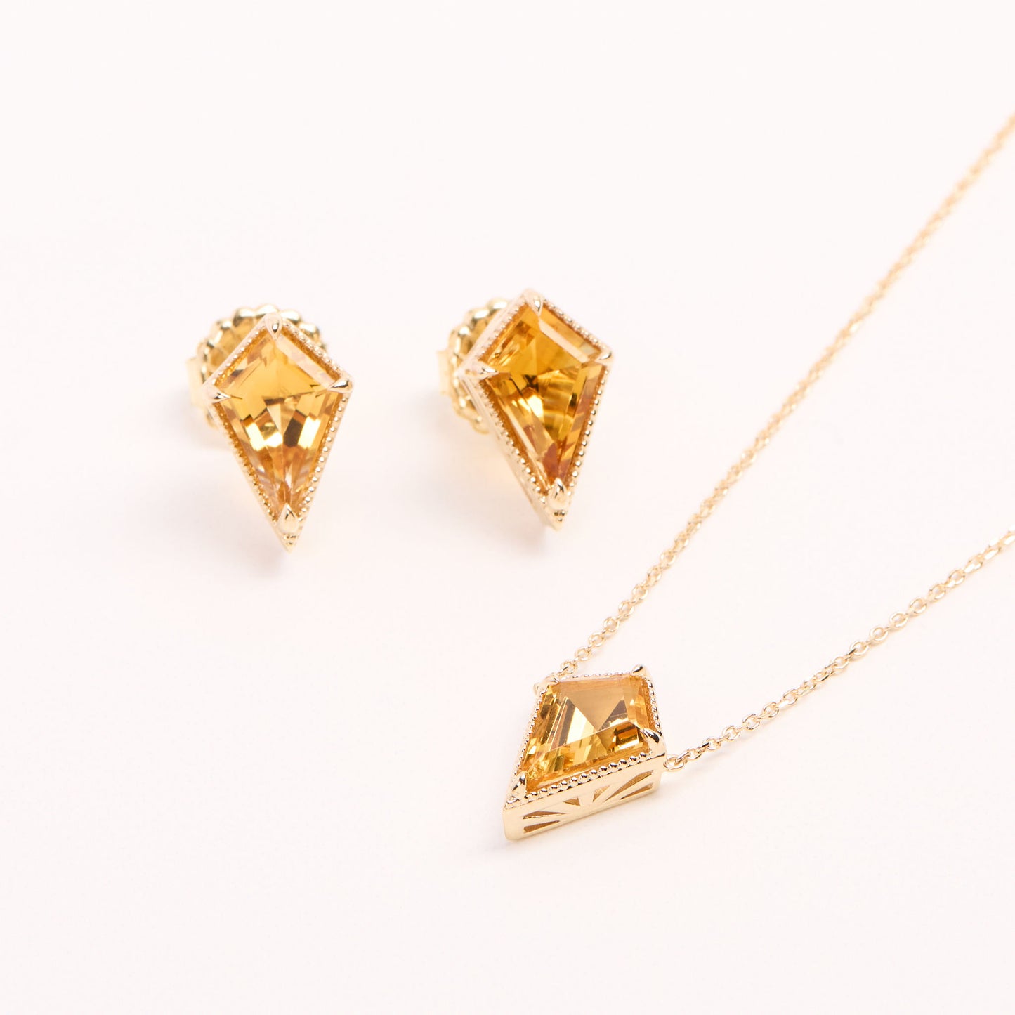angled view of the soleil necklace and stud earrings on a white background