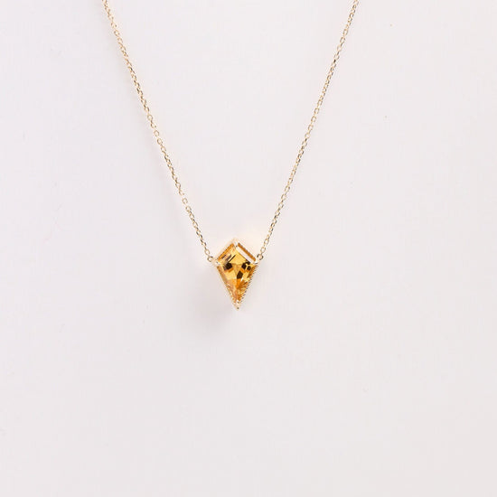 kite shaped citrine pendant necklace on a white background