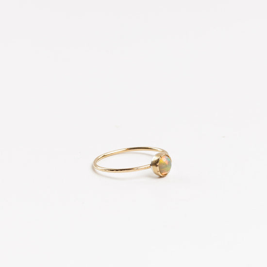 side view of the Ethiopian opal mini ring on a white background