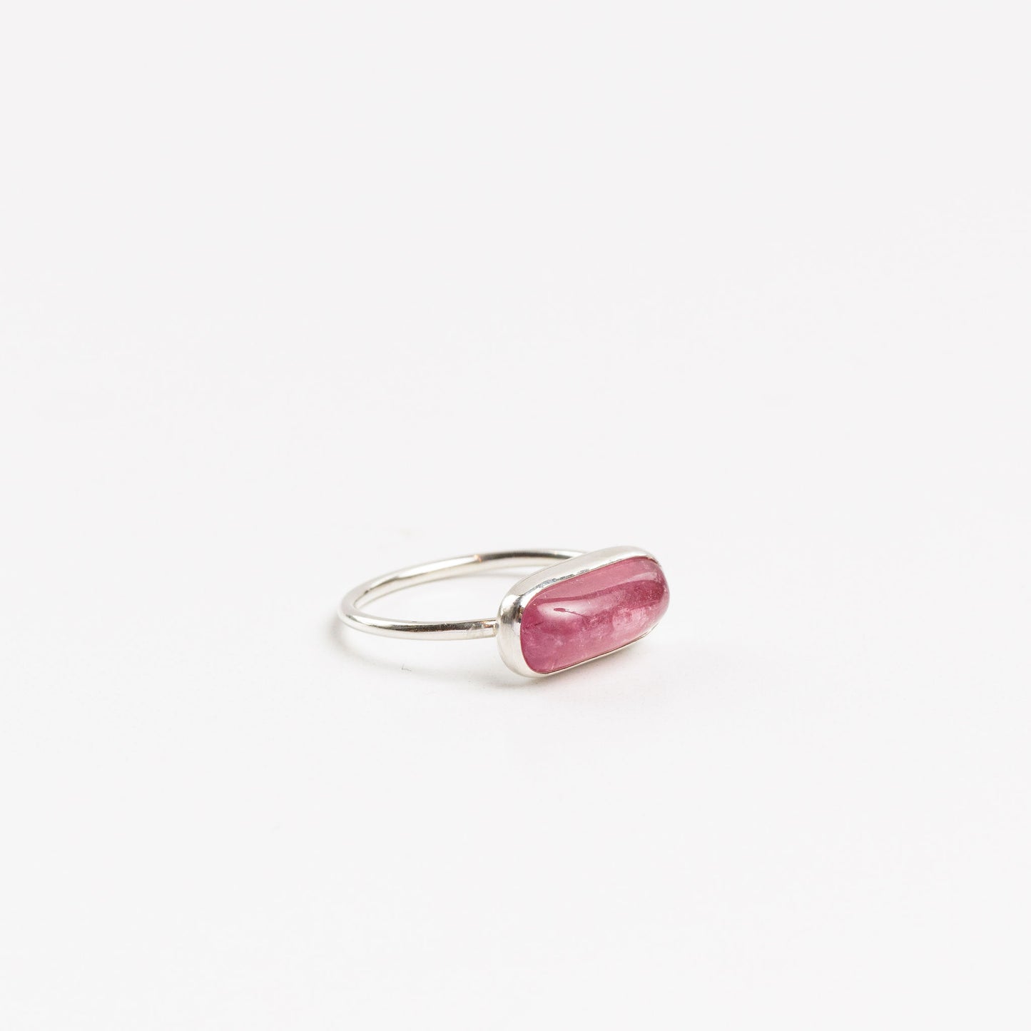side view of the sterling silver pink tourmaline ring on a white backlground