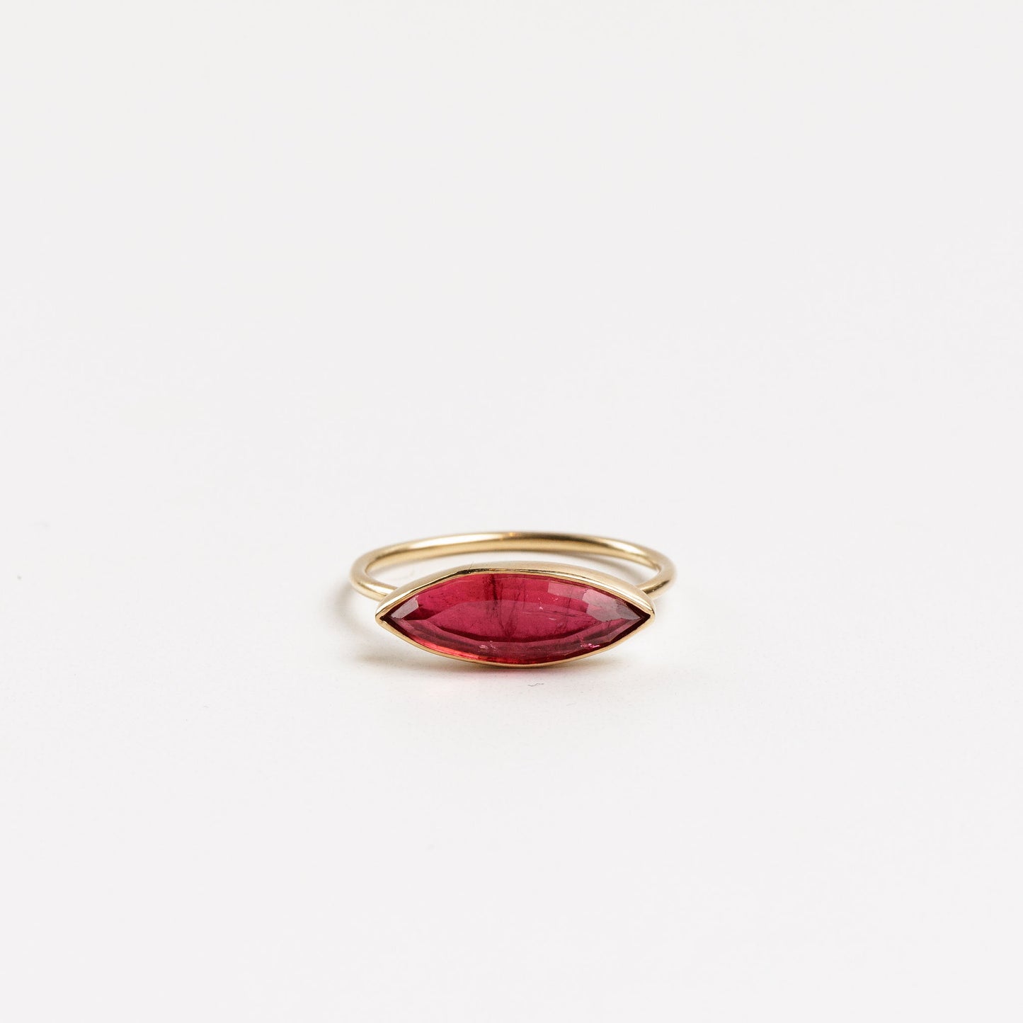 marquise pink tourmaline gold ring on a white background