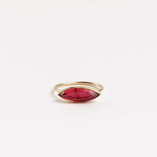 marquise pink tourmaline gold ring on a white background