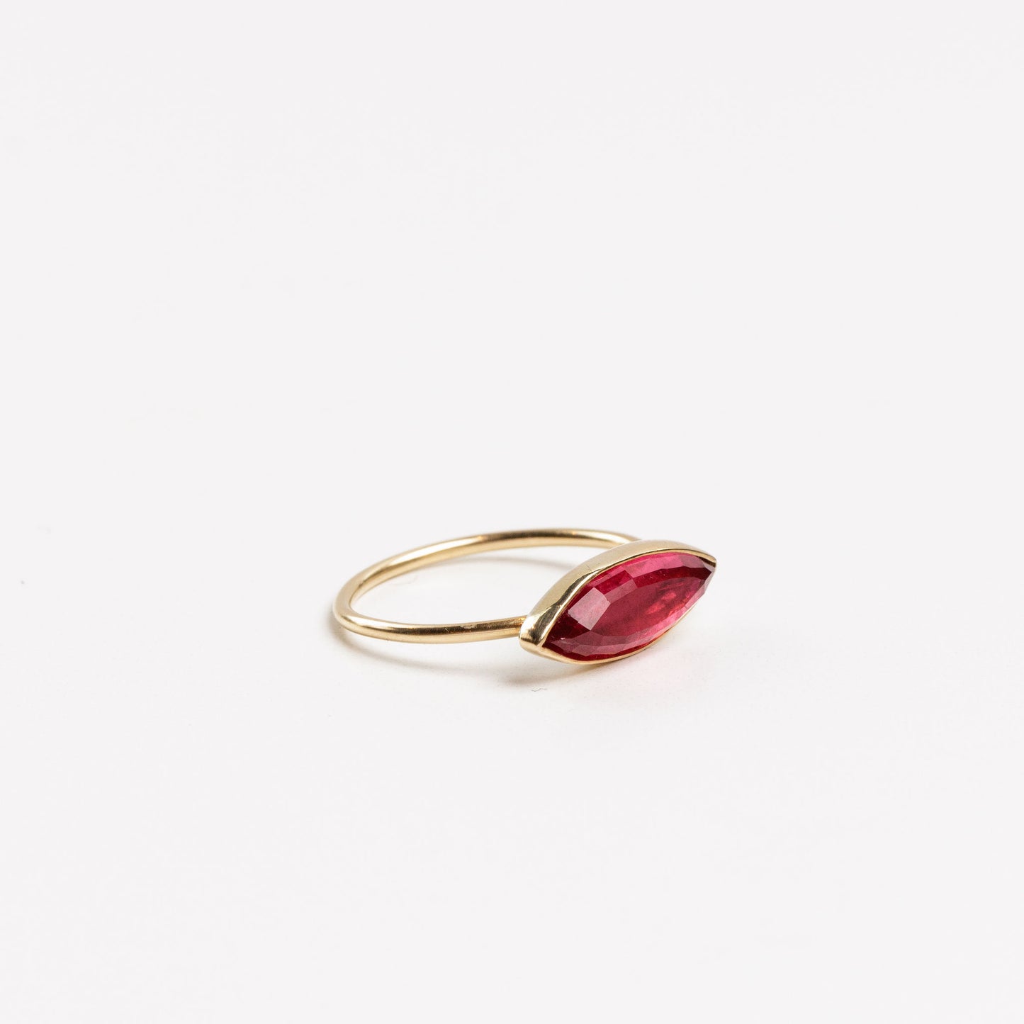 side view of the pink tourmaline marquise ring on a white background