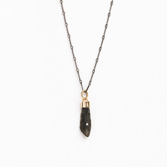 oxidized silver necklace with basalt stone charm with diamond accent on white background