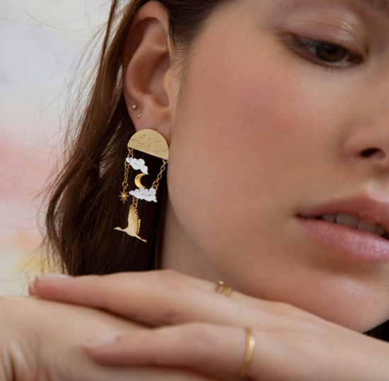 close up of a model wearing the dream earrings