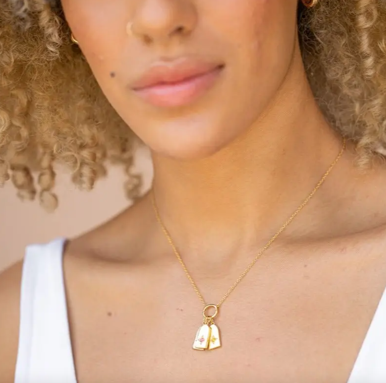 model wearing an iris birthstone charm necklace with two charms