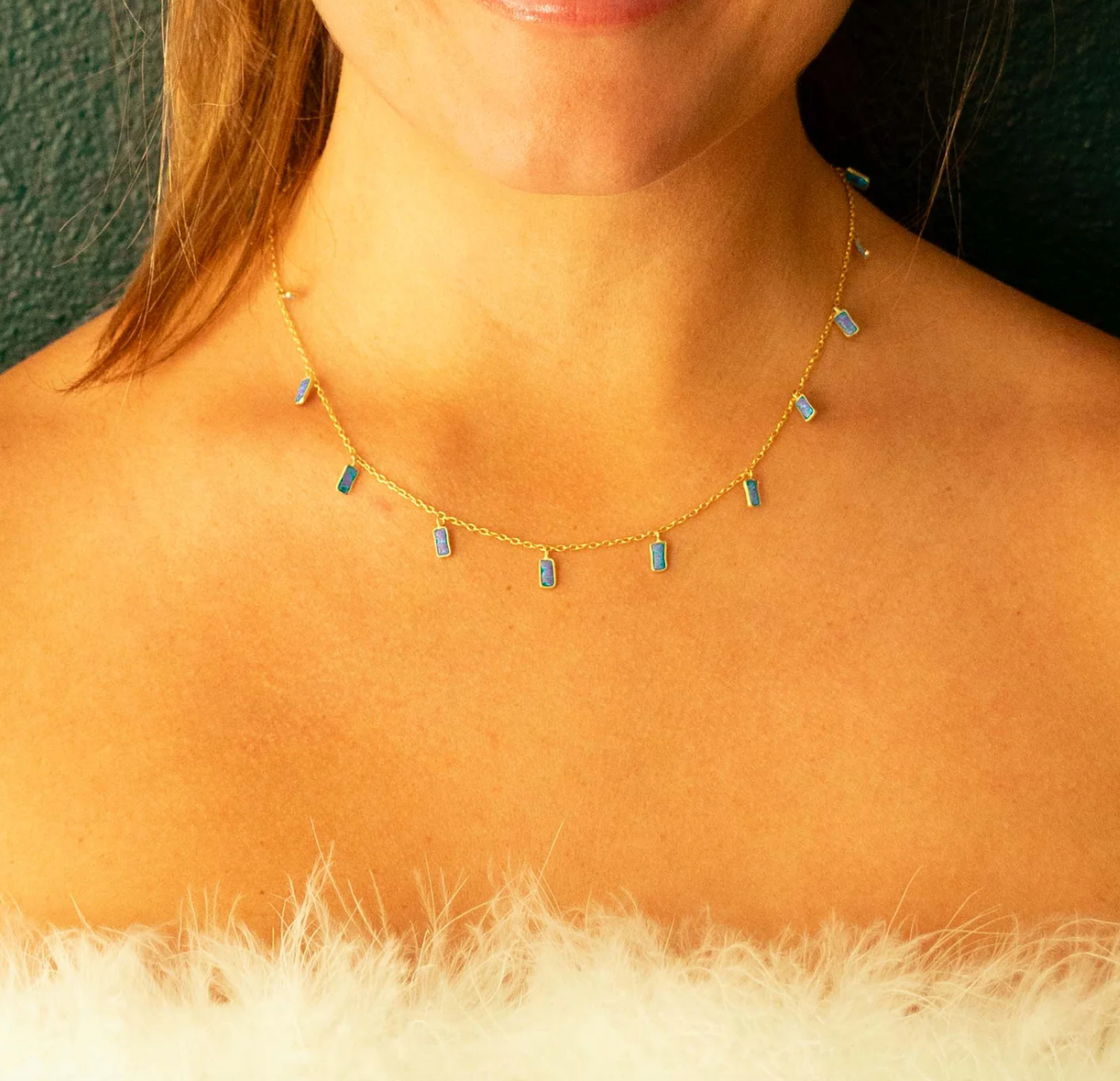 close up of a model wearing the blue opal rectangle necklace