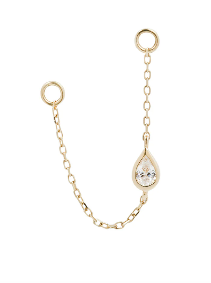 gold chain earring charm with a bezel set pear shaped cubic zirconia on a white background