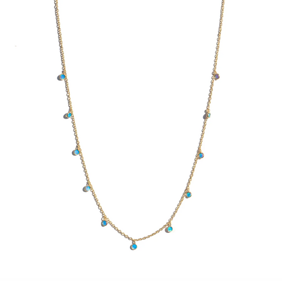 gold chain necklace with 11 small round blue opal charms on a white background