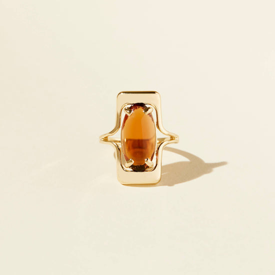 front view of the amber colored walton ring on a beige background