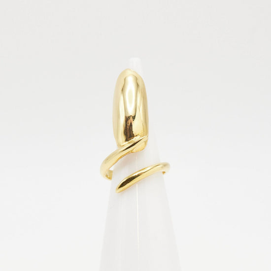 gold nail ring on ring cone with white background