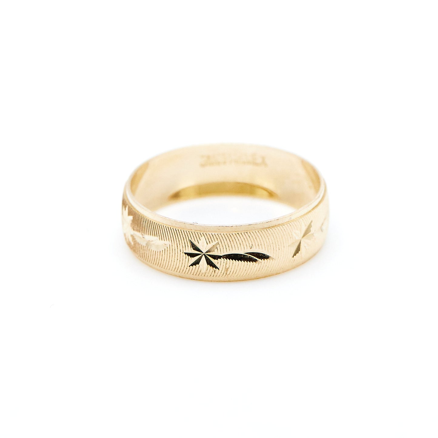 yellow gold band with shooting star and ribbed texture engraving