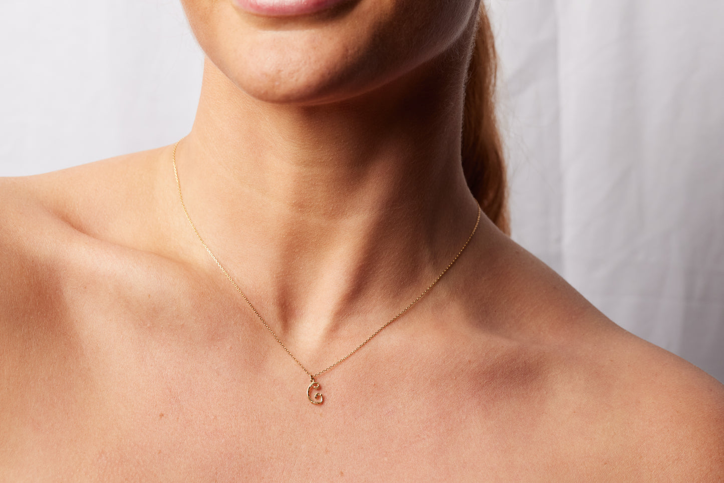 model wearing the C initial necklace