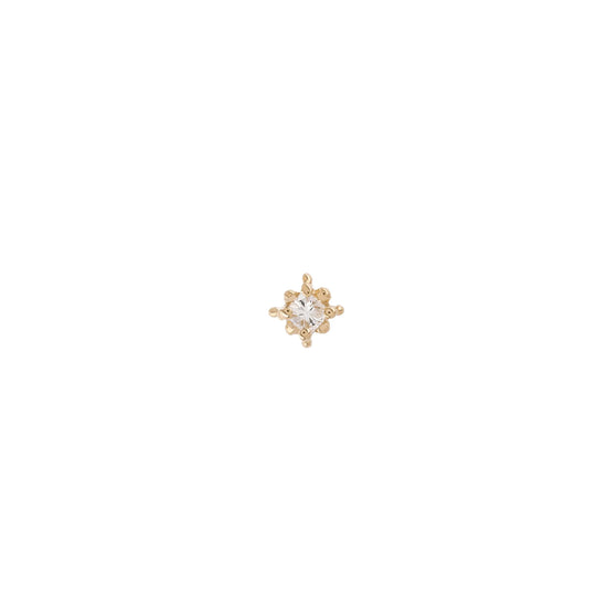 a single diamond stud earring with gold prong details on a white background