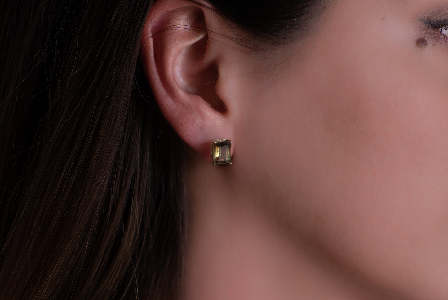 Close up profile shot of emerald cut earrings on a model