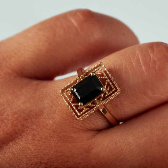 the geometric rectangle shaped zelda ring with black spinel center stone on model close up