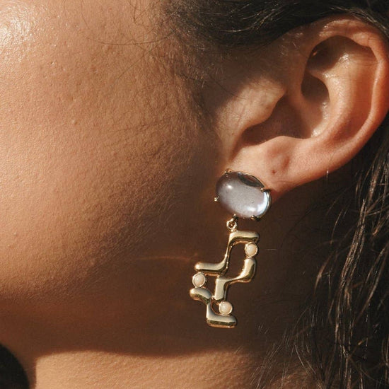 close up of a model wearing the halsted earring
