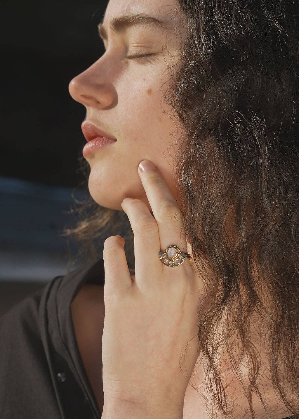 Close-up of a woman with a ring on her finger, with a blurred background
