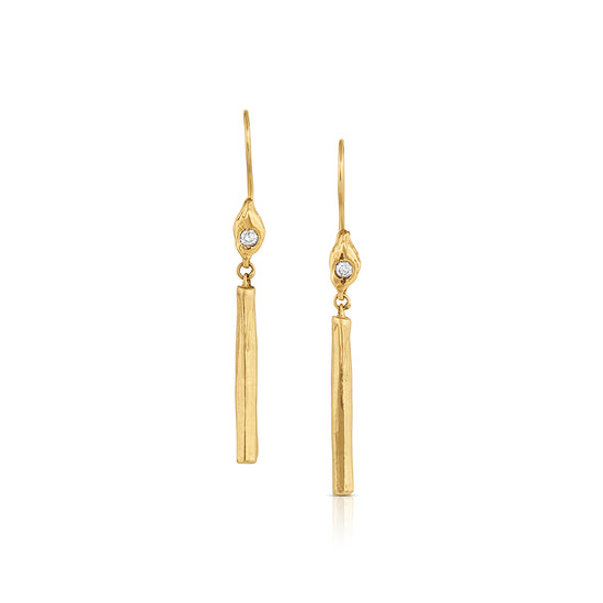 gold candle stick earrings with white diamond flame on white background