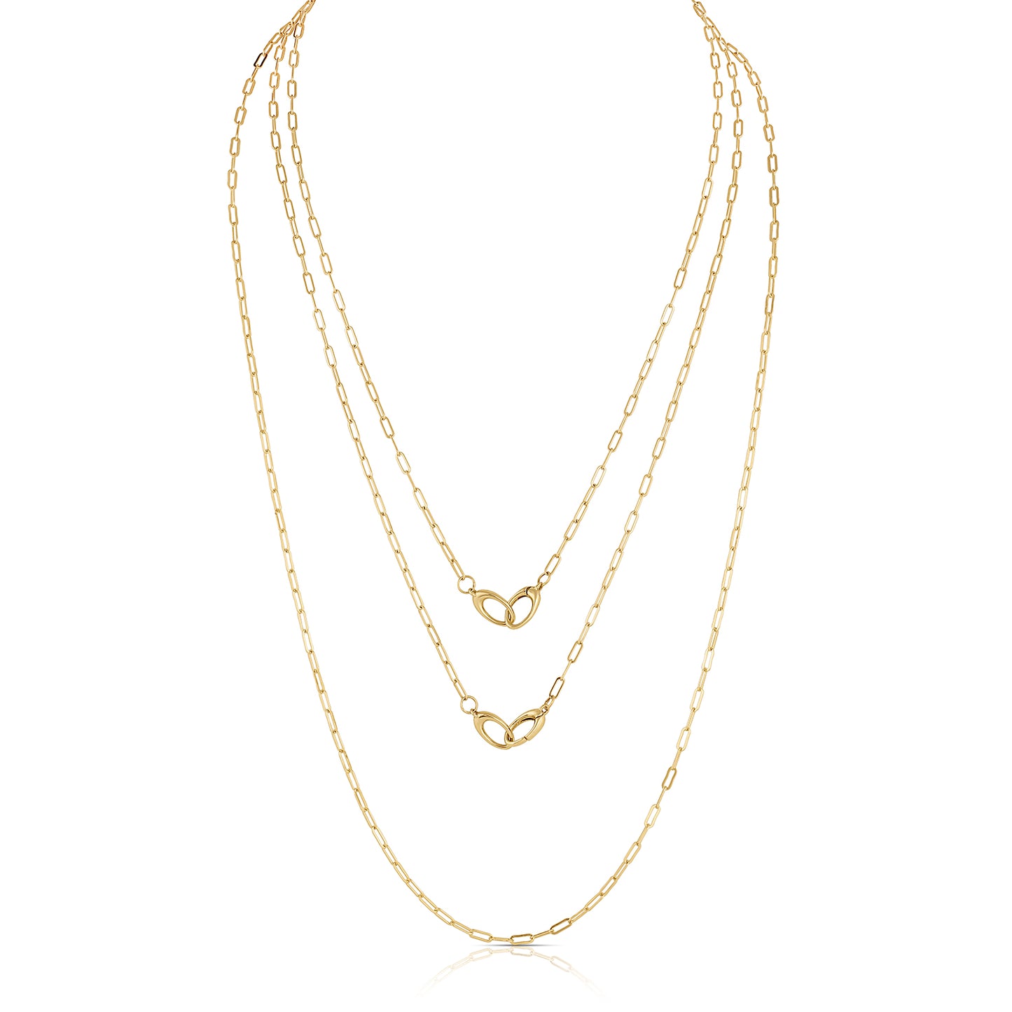 three gold chains layered on a white background