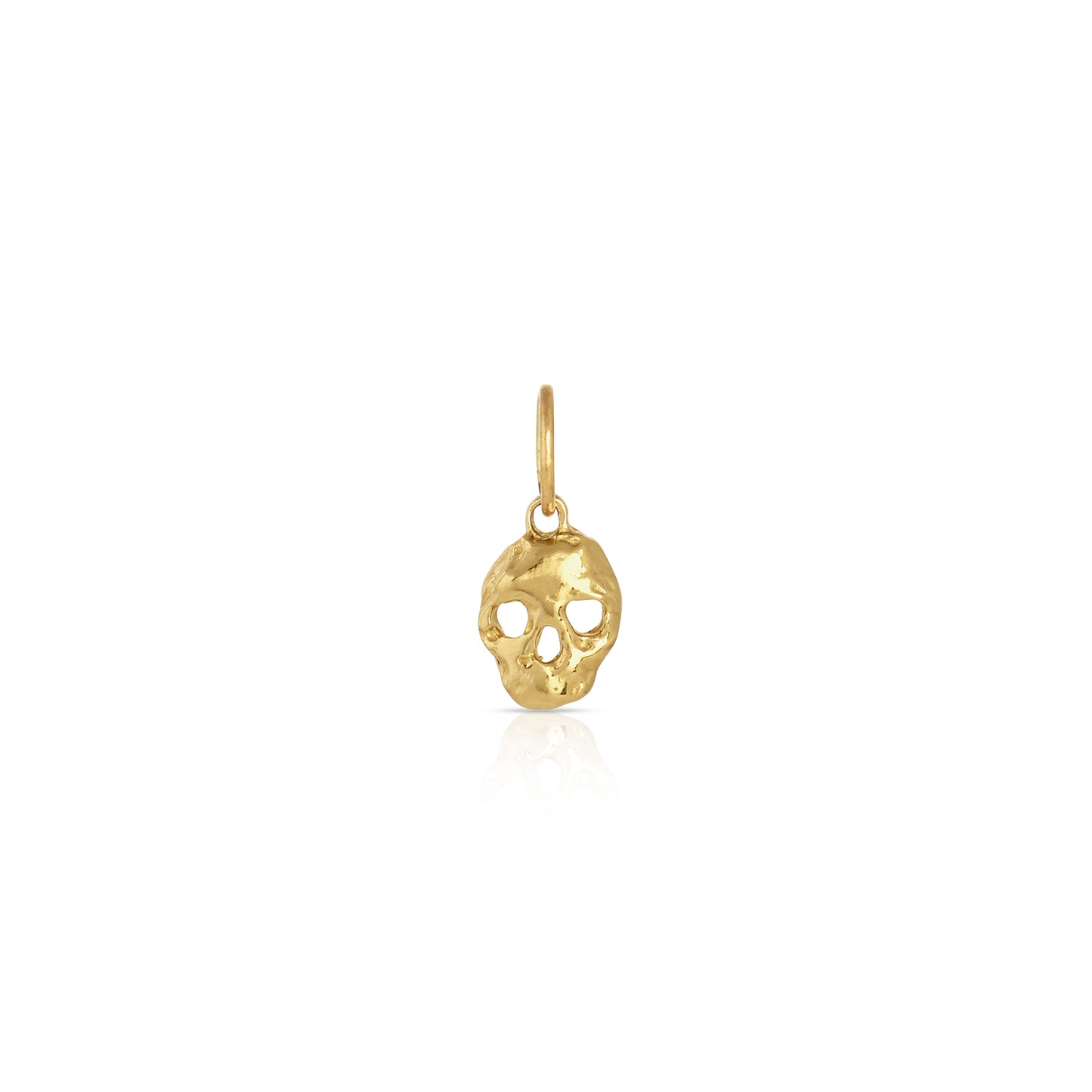 gold skull shaped charm on a white background