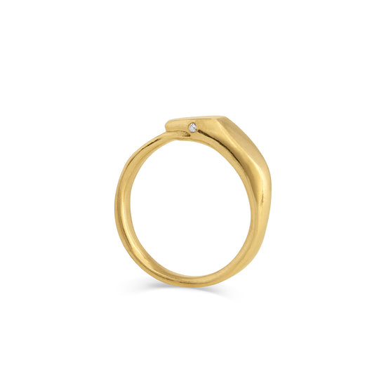 gold ring with snake eating it's tail and white diamond eyes on a white background