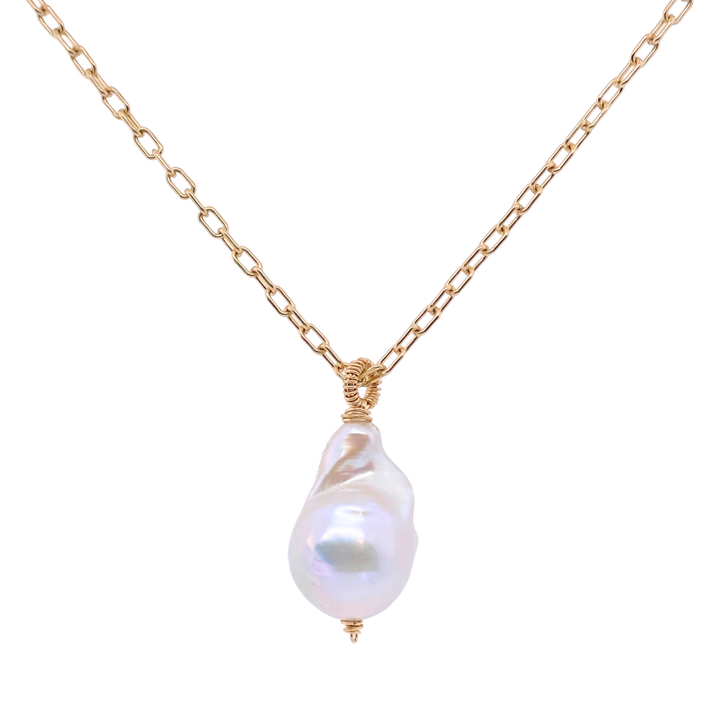 gold chain necklace with irregular shaped pearl pendant on a white background