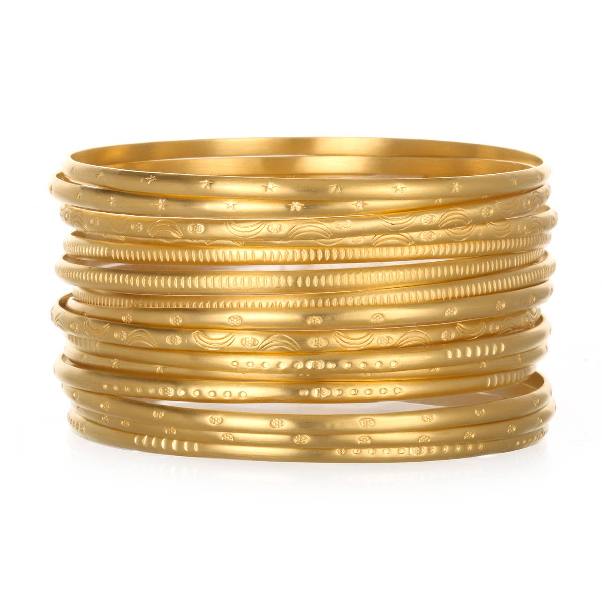 Fourteen skinny gold engraved bangles sitting on top of each other on a white background