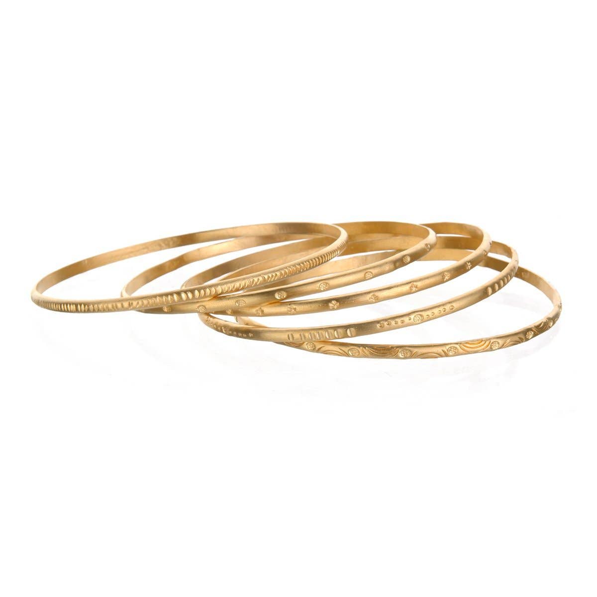 layered stack of five gold engraved bangles on a white background