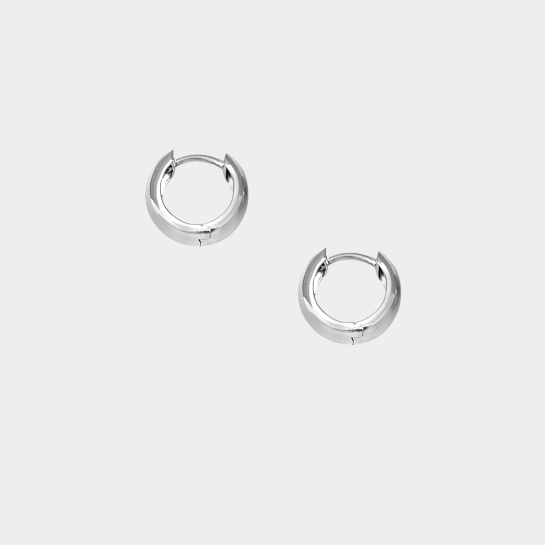 Pair of silver hoop earrings on a light gray background