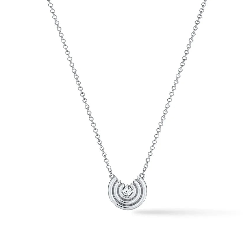 Silver semi circle pendant with white sapphire center on white background