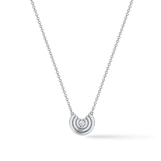 Silver semi circle pendant with white sapphire center on white background