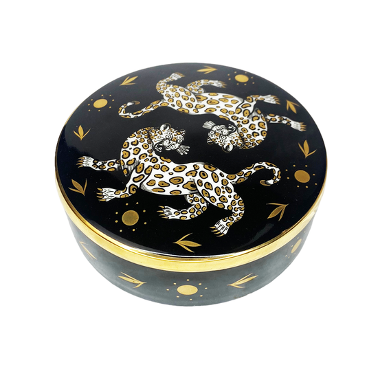 black trinket box with gold decorative accents and two mirrored leopards on a white background