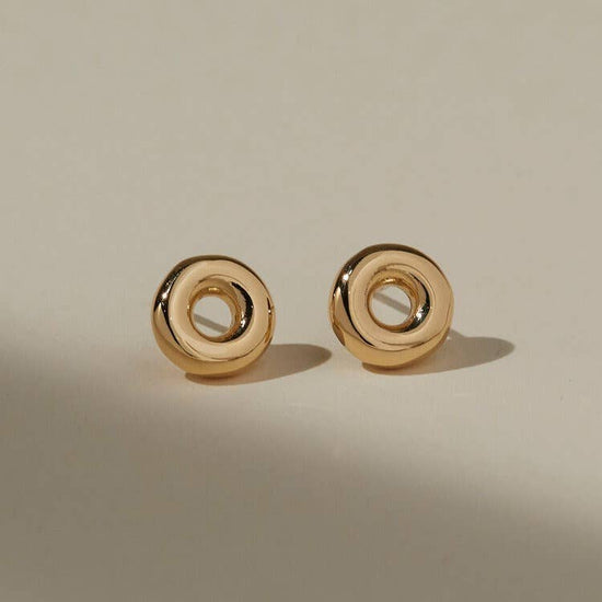 front view of the mia studs on a beige background