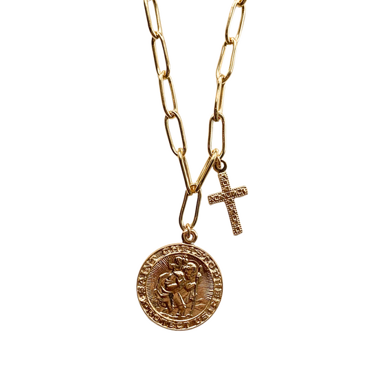 a gold saint christopher coin pendant and a gold cross dangle from a gold paperclip chain on a white background