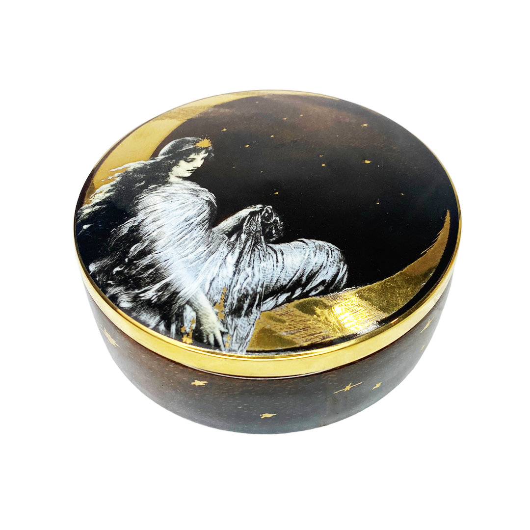 black trinket box with a woman sitting on a golden moon amongst gold stars
