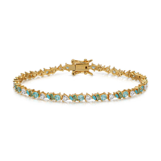 Gold bracelet with turquoise and white gemstones on a white background