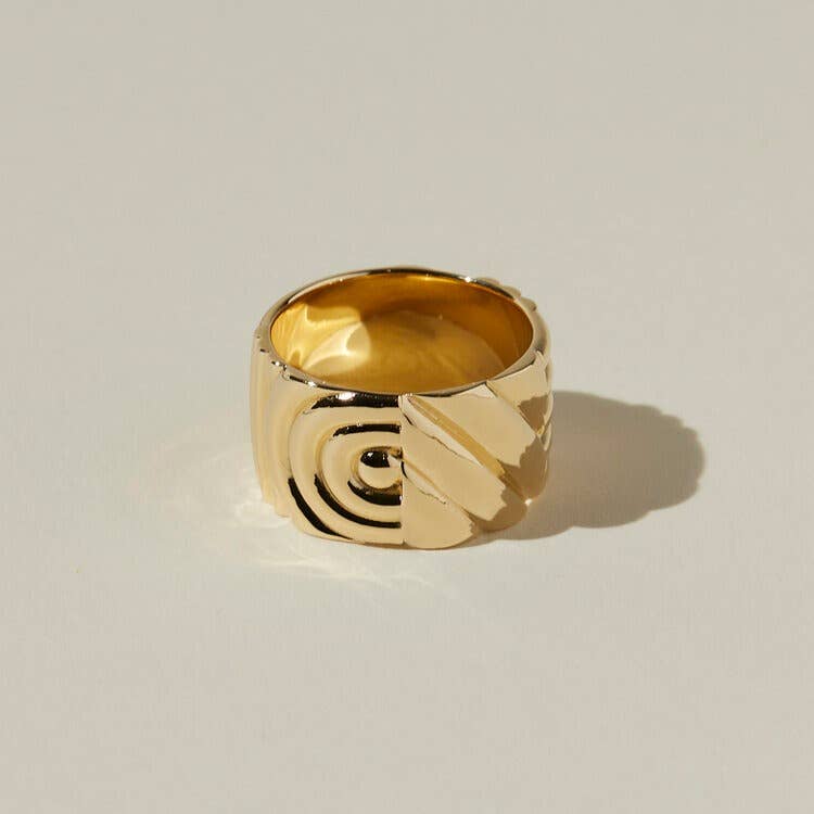 another view of the ribbed and textured design of the chloe ring on a beige background