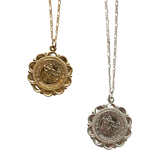 a gold and silver scalloped coin pendant with saint Christopher on a white background