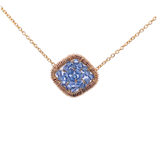 diamond shaped gold pendant adorned with blue crystal beads on white background