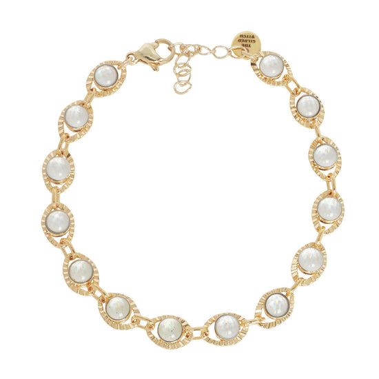 Gold bracelet with glass stones  in shape of an eye on a white background