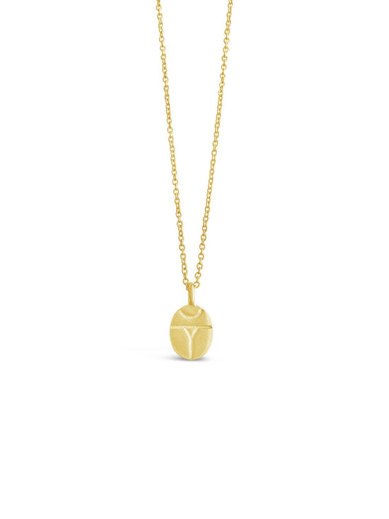 Gold necklace with a round pendant on a white background