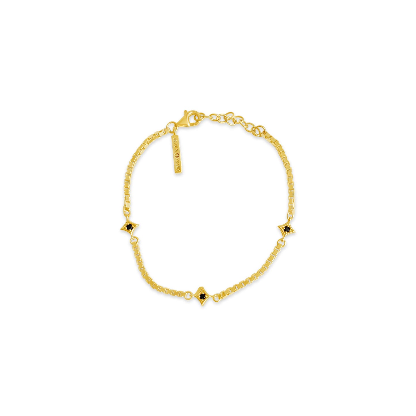 Gold bracelet with small spinel on a white background