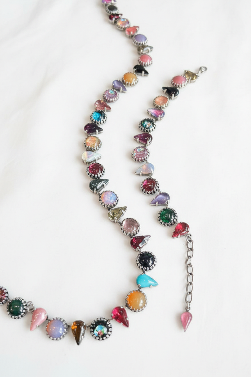 Necklace with colorful gemstones on a dark surface
