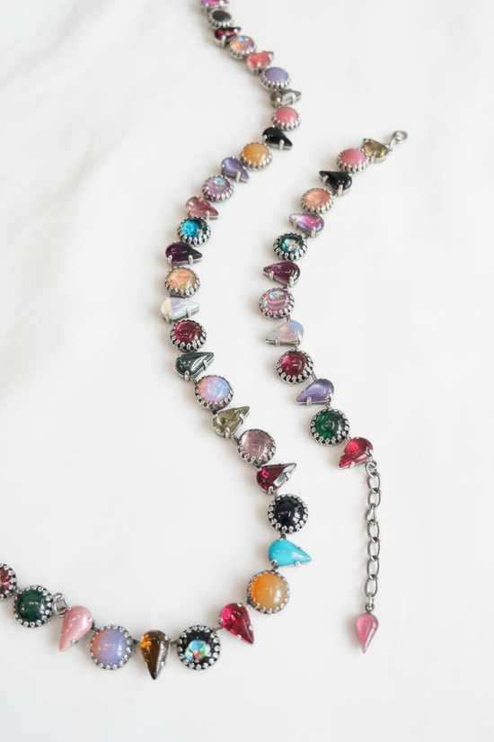 Necklace with colorful gemstones on a dark surface