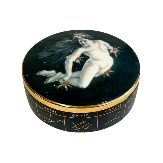 round ceramic trinket dish with a lady floating amongst stars and the zodiac signs and symbols around the side, on a white background

