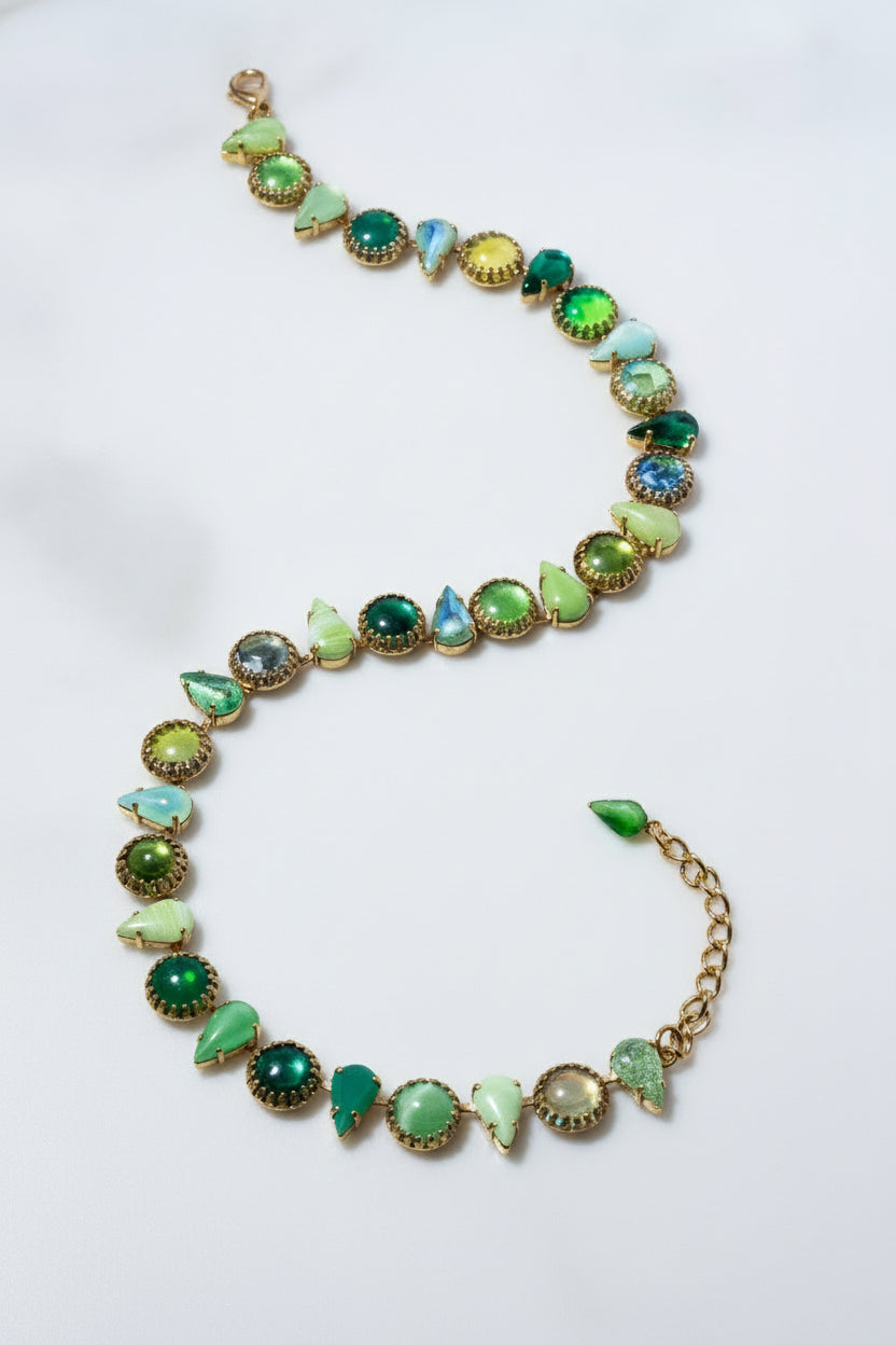 Necklace with green gemstones on a white background