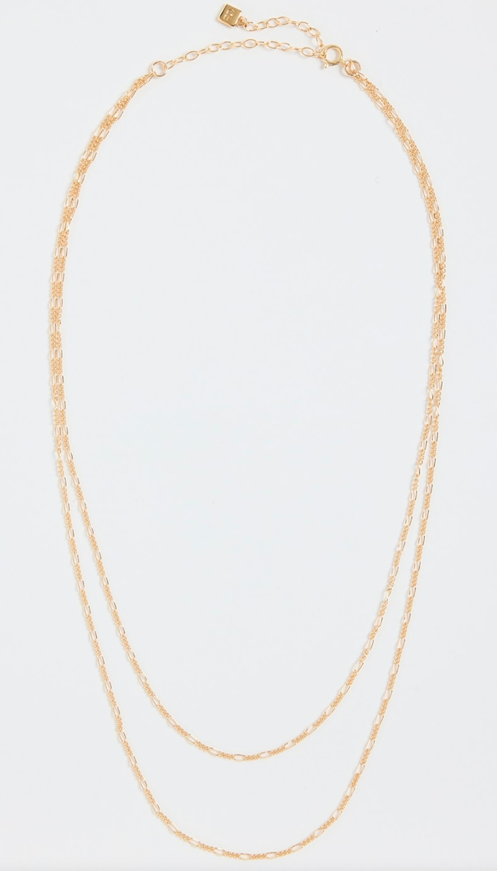 gold double chain necklace on a white background