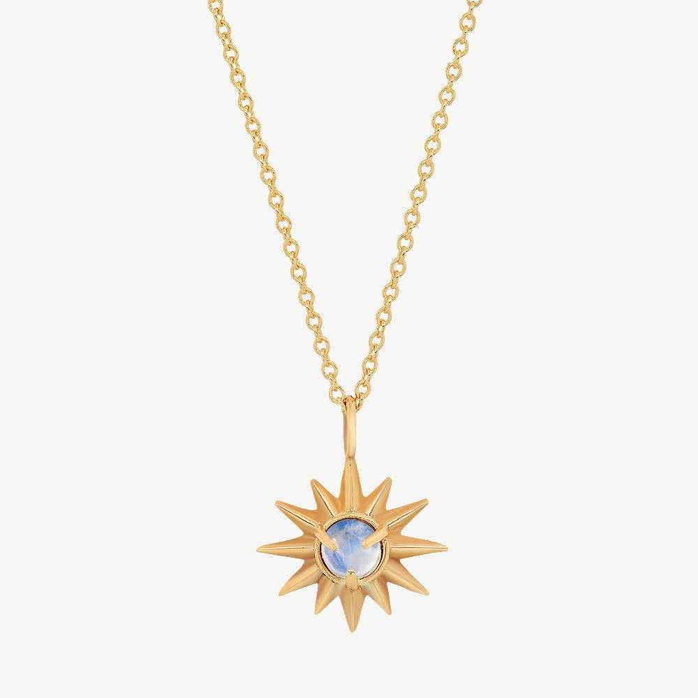 Gold necklace with a sun-shaped pendant on a white background